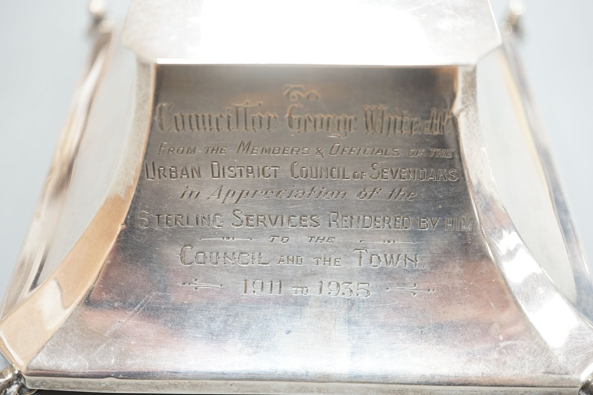 A George V silver mounted inkwell, Birmingham, 1924, with presentation inscription and monogram, 14.2cm.